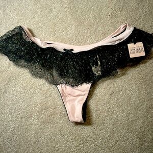 Unused Victoria’s Secret pink with black and gold lace thong, tag attached